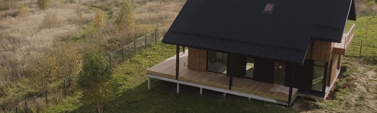 A Bungalow of Family, Farm, and Architecture Residing Amidst the Beautiful Landscape of Trees, Grass, and Wooden Structures